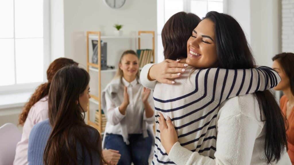 Client receiving supportive care inside a calm, residential style wellness center.